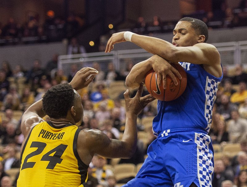 Missouri's Kevin Puryear, left, defends as Kentucky's Keldon Johnson, right, tries to pull in a rebound during the first half of an NCAA college basketball game Tuesday, Feb. 19, 2019, in Columbia, Mo. (AP Photo/L.G. Patterson)