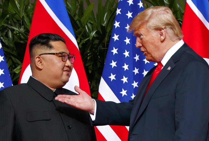 In this June 12, 2018, file photo, U.S. President Donald Trump, right, meets with North Korean leader Kim Jong Un on Sentosa Island in Singapore. With their second summit fast approaching, speculation is growing that Trump may try to persuade Kim to commit to denuclearization by giving him something he wants more than almost anything else, an announcement of peace and an end to the Korean War. (AP Photo/Evan Vucci, File)