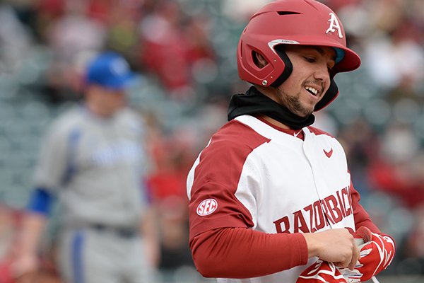 Arkansas center fielder Dominic Fletcher takes off his batting gloves after making an out against Eastern Illinois Saturday, Feb. 16, 2019, at Baum-Walker Stadium in Fayetteville.