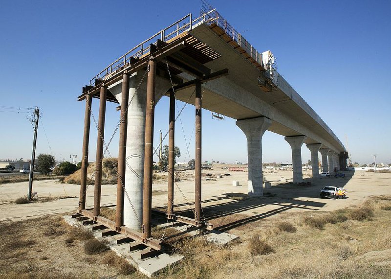 A section of California’s high-speed rail project is shown under construction in Fresno in December 2017. After Gov. Gavin Newsom said he planned to scale back the project, the Trump administration announced it will cancel a $929 million grant for the project and wants the state to return $2.5 billion in federal funds previously granted. 