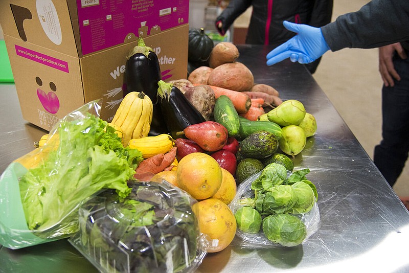 This Nov. 13, 2018 file photo shows various fruit and vegetables at Imperfect Produce in Severn, Md. The company delivers produce that have been rejected by grocery stores for not fitting cosmetic standards. (Joshua McKerrow/The Baltimore Sun via AP)