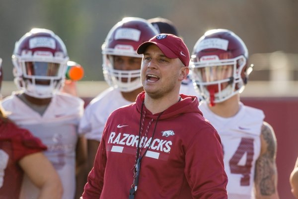 Justin Stepp, Arkansas wide receivers coach, runs a drill Thursday, March 1, 2018, during Arkansas spring football practice at the Fred W. Smith Football Center in Fayetteville.
