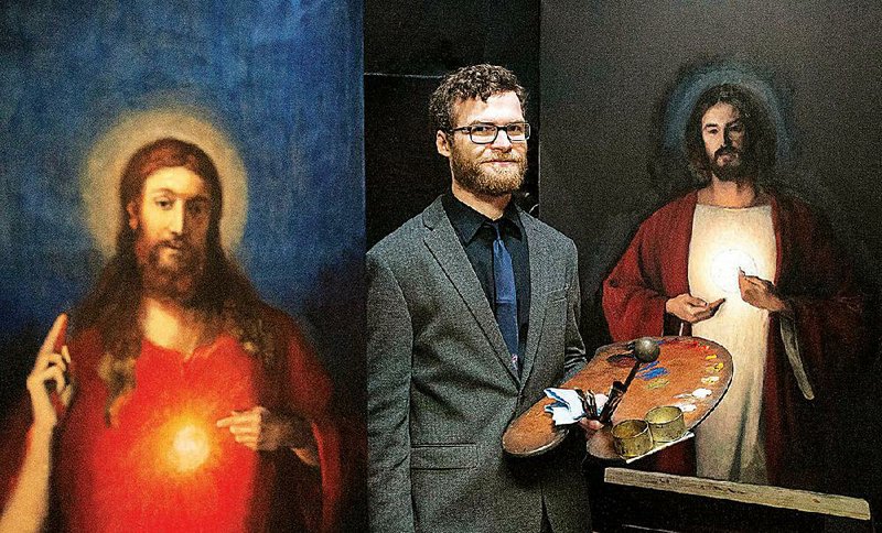 Robert Puschautz stands between two of his paintings, two versions of the Sacred Heart of Jesus, that are in progress at his studio in Tyler, Texas. 