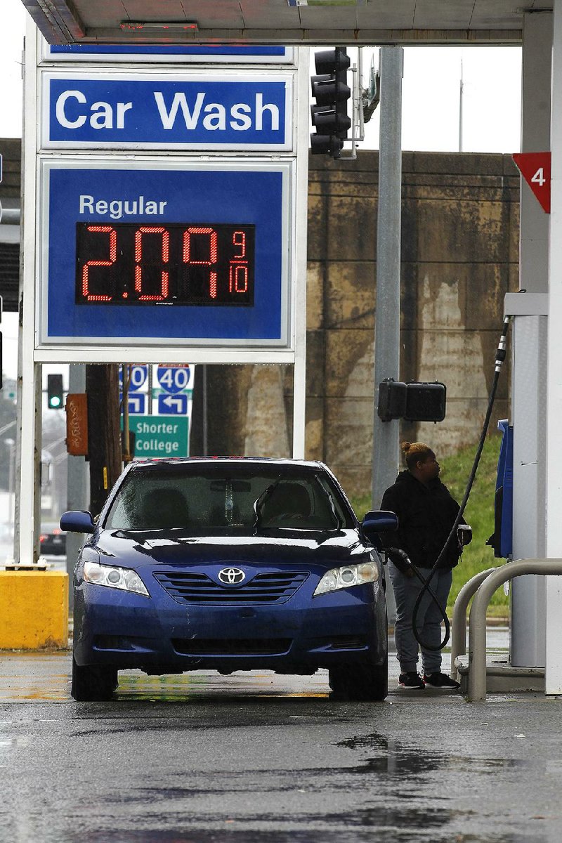 Nikita James of Maumelle makes a fuel stop Thursday at the Exxon station on West Broadway in North Little Rock. Despite recent increases, Arkansas gas prices remain some of the nation’s lowest. 