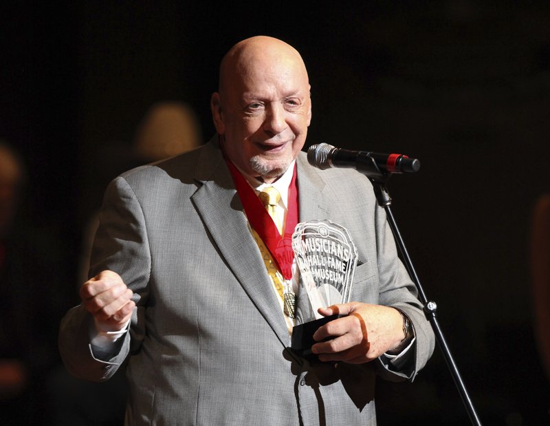 FILE - In this Oct. 12, 2009 file photo, Fred Foster speaks as he is inducted into the Musicians Hall of Fame at the Musicians Hall of Fame awards show in Nashville, Tenn. Foster, who produced some of Roy Orbison's most iconic records and was the first to produce records from Kris Kristofferson and Dolly Parton, has died at the age of 87. His publicist, Martha Moore, said Foster died Wednesday, Feb. 20, 2019 in Nashville. (AP Photo/Josh Anderson, File)