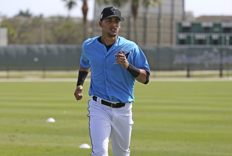 FILE - In this Feb. 18, 2019, file photo, Miami Marlins outfielder Victor Victor Mesa runs drills at the team's spring training baseball facility in Jupiter, Fla. Last offseason the Miami Marlins signed a highly touted Cuban defector, and if he lives up to his name, he could help revive a franchise that has done nothing but lose and lose: Victor Victor Mesa. (David Santiago/Miami Herald via AP, File)