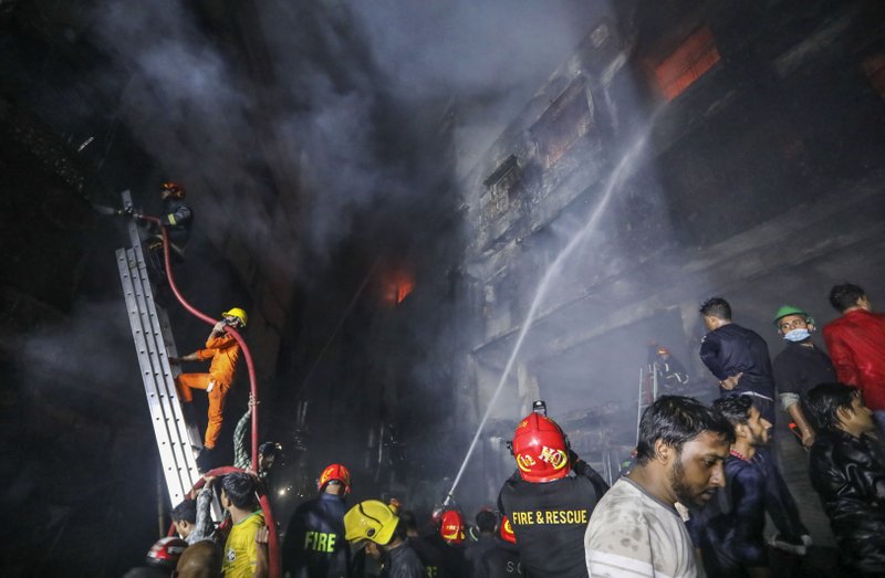 Firefighters work to douse flames Thursday in a centuries-old area of Dhaka, Bangladesh. 