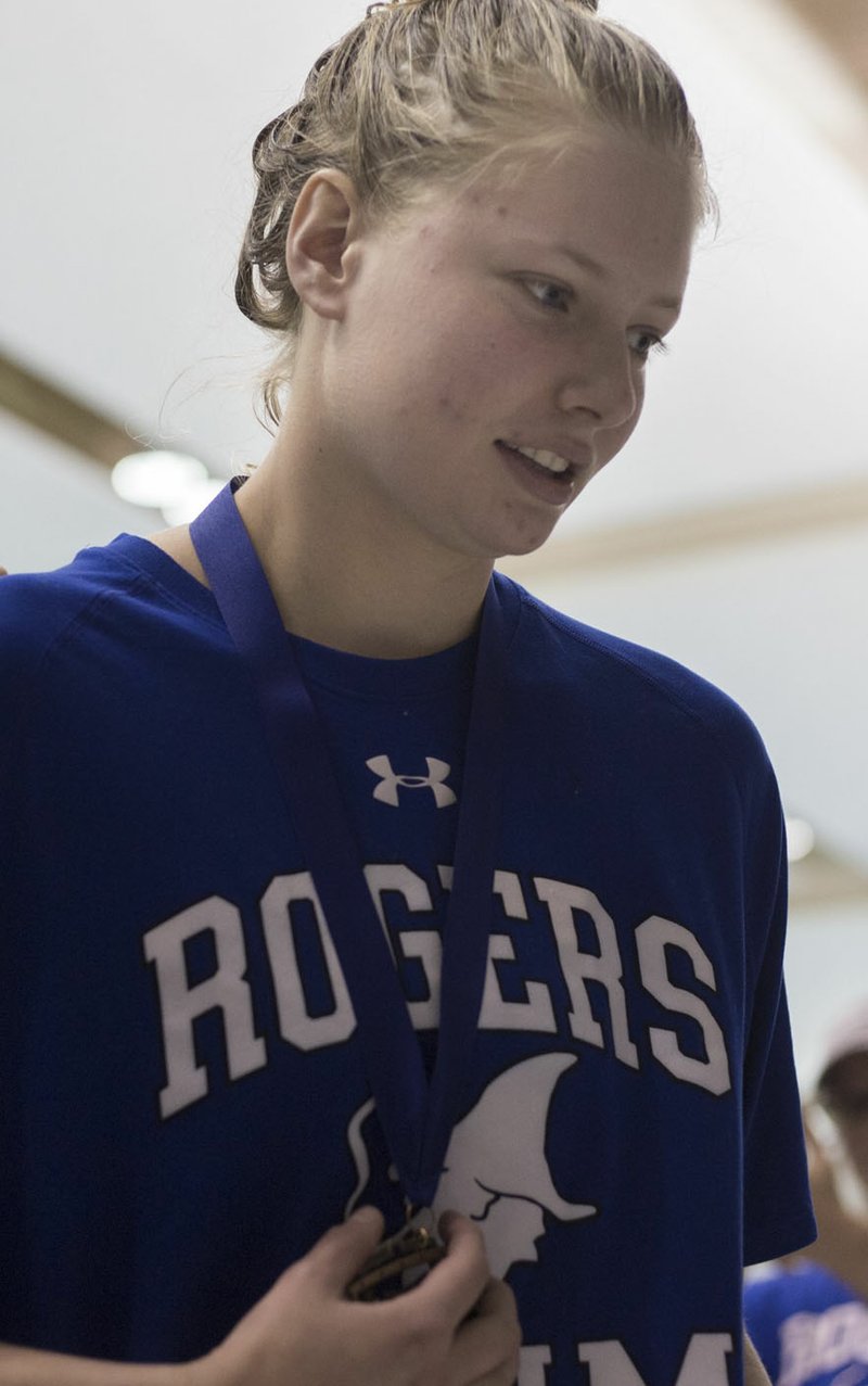 NWA Democrat-Gazette/CHARLIE KAIJO Rogers Kristen Stalder accepts her award for the girls 100 yard butterfly during a swim meet, Saturday, February 9, 2019 at the University of Arkansas HYPER pool in Fayetteville.