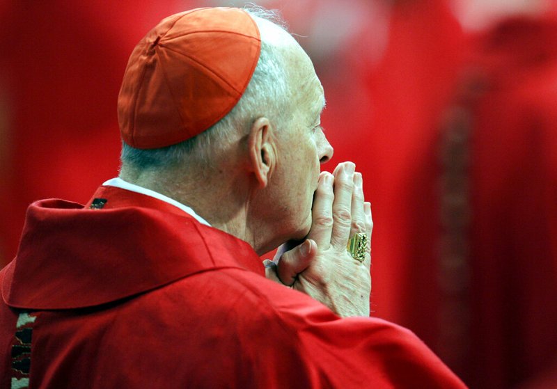 In this Monday, April 18, 2005 file photo, U.S. Cardinal Theodore Edgar McCarrick attends a Mass in St. Peter's Basilica at the Vatican. On Saturday, Feb. 16, 2019 the Vatican announced Pope Francis defrocked former U.S. Cardinal Theodore McCarrick after Vatican officials found him guilty of soliciting for sex while hearing Confession. (AP Photo/Pier Paolo Cito, files)