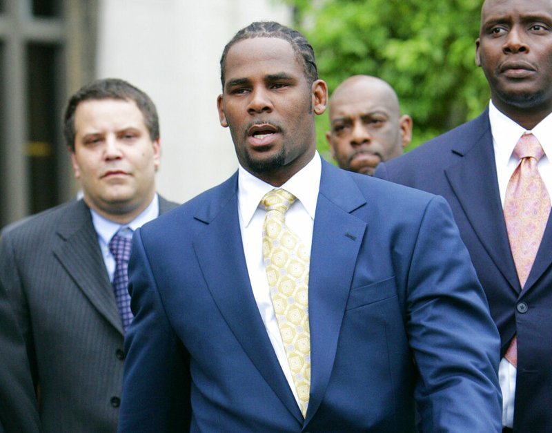 In this June 13, 2008 file photo, R&amp;B singer R. Kelly leaves the Cook County Criminal Court Building in Chicago after a jury found him not guilty on all counts in his child pornography trial. In 2002, Kelly was indicted on 21 counts of child pornography, based on a videotape allegedly showing him having sex with an underage girl. (AP Photo/Nam Y. Huh, File)