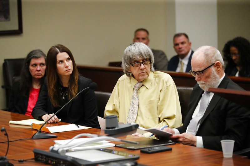 David Turpin, second from right, and wife, Louise, far left, listen to their charges as they are joined by their attorneys, Allison Lowe, second from left, and David Macher in a courtroom Friday, Feb. 22, 2019, in Riverside, Calif. The California couple who shackled some of their 13 children to beds and starved them pleaded guilty Friday to torture and other abuse in a case dubbed a "house of horrors." (AP Photo/Jae C. Hong, Pool)