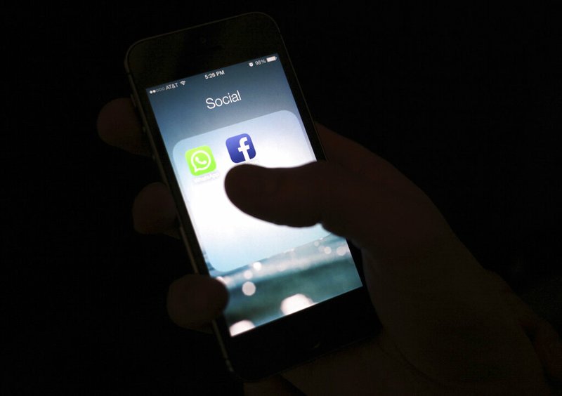 This Feb. 19, 2014, file photo shows the Facebook app icon on an iPhone in New York. The Wall Street Journal is reporting that several phone apps are sending sensitive user data to Facebook, including health information, without users' consent. The report says an analytics tool called "App Events" allows app developers to record user activity and report it back to Facebook, even if the user isn't on Facebook. (AP Photo/Karly Domb Sadof, File)