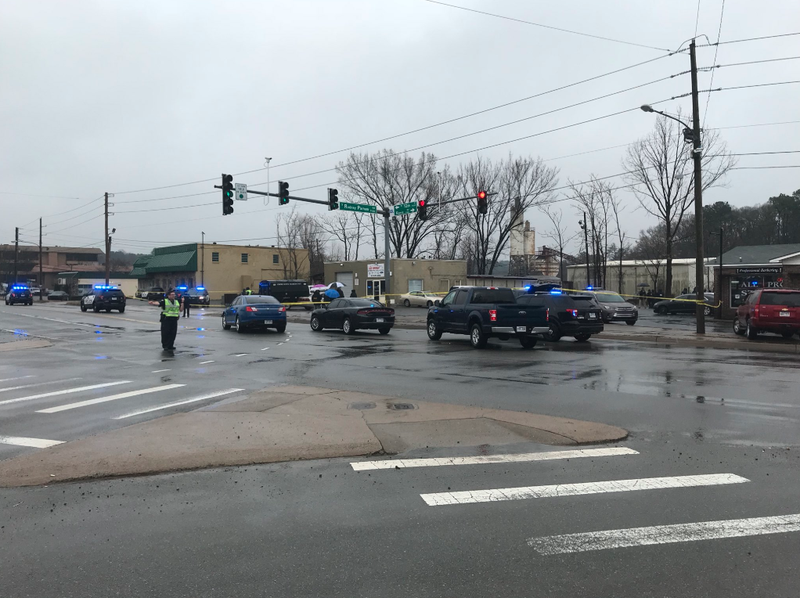 Authorities investigate a shooting involving a police officer near 12th Street and Rodney Parham Road on Friday morning.