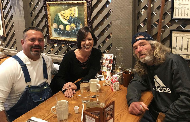Dawn and Jody Gieber sit at a Cracker Barrel with James Anderson (right) while on a trip to take him home to Illinois on Nov. 9. Anderson had been living on the streets of Little Rock for 15 years until the couple befriended him and arranged to take him back to his family. 