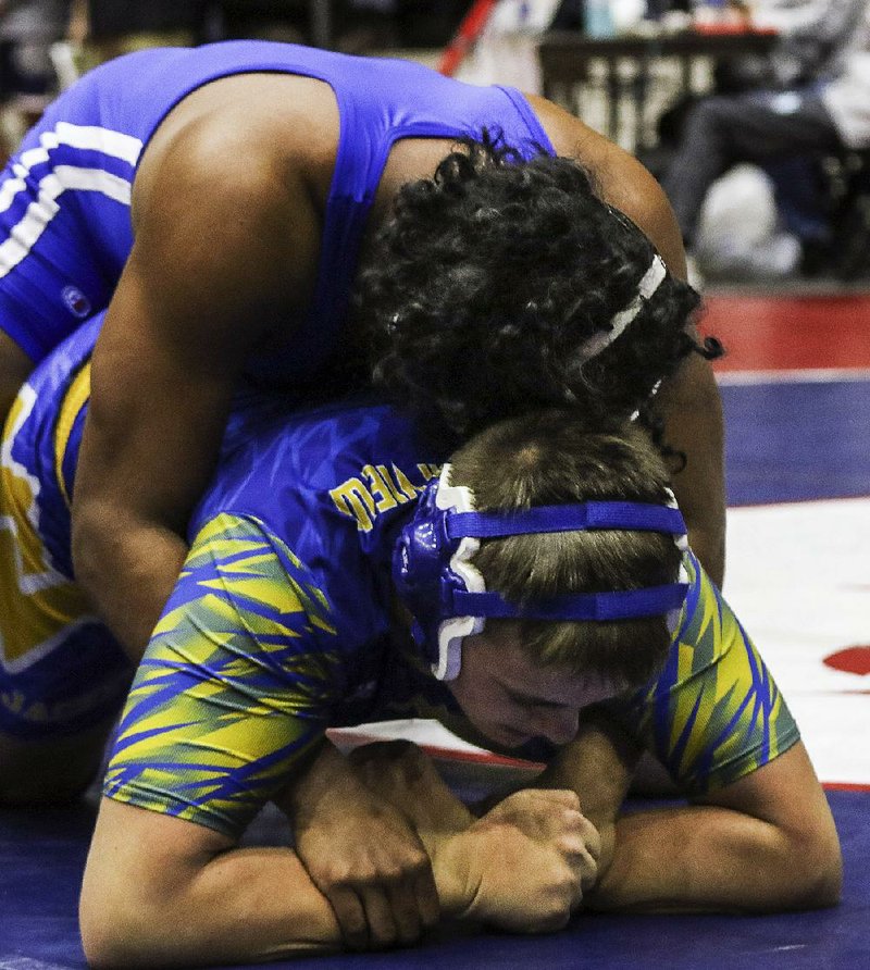 Arkadelphia’s Rickey Rogers Jr. (above) controls on top against Mountain View’s Tanner Trammell on Friday at the state high school wrestling tournament in Little Rock. Rogers won by pin.