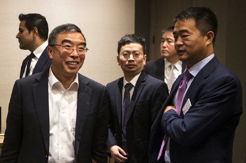 Liang Hua (left), board chairman of Huawei Technologies Co., and Eric Li (right), president of Huawei’s Canadian unit, leave a media event Thursday in Toronto. Canada in December arrested a Huawei executive at the request to the U.S. 