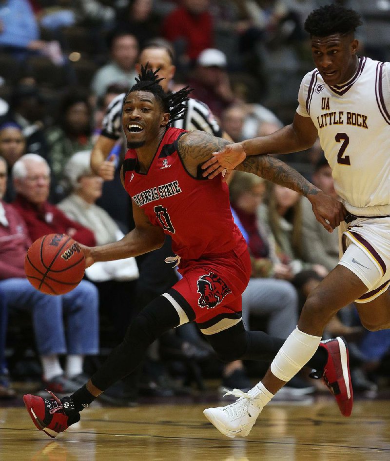 Arkansas State’s Ty Cockfield (left) led all scorers with 28 points during the Red Wolves’ 84-83 victory over UALR in the teams’ first meeting Feb. 2 at the Jack Stephens Center in Little Rock. 