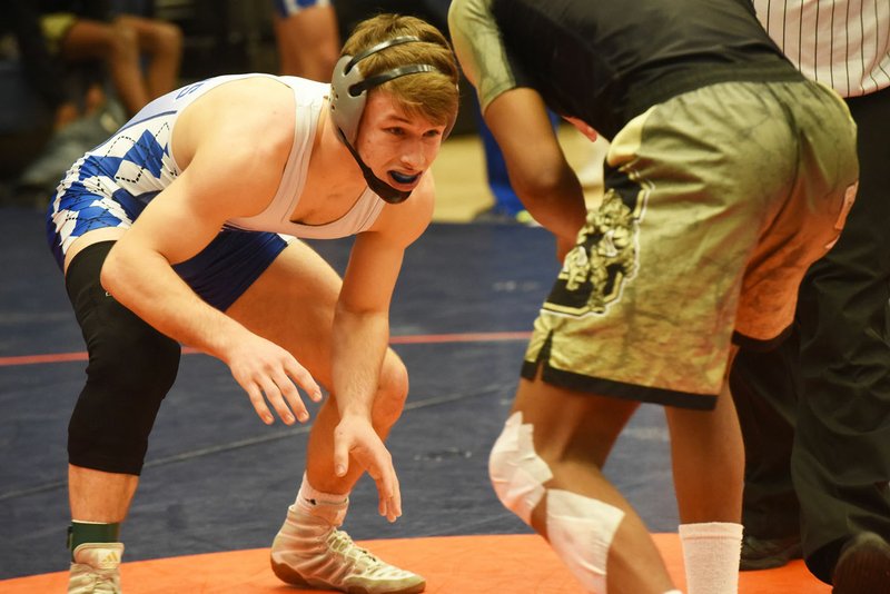 NWA Democrat-Gazette/FLIP PUTTHOFF Rogers High's Jake Turner (left) will try to claim his third consecutive state wrestling title today in the Class 6A state tournament at The Stephens Center in Little Rock.