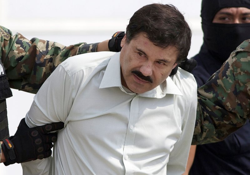 This Feb. 22, 2014 file photo shows Joaquin "El Chapo" Guzman, the head of Mexico's Sinaloa Cartel, being escorted to a helicopter in Mexico City following his capture in the beach resort town of Mazatlan. 