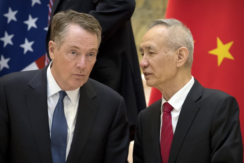In this Feb. 15, 2019, file photo, Chinese Vice Premier Liu He, right, talks with U.S. Trade Representative Robert Lighthizer, while they line up for a group photo at the Diaoyutai State Guesthouse in Beijing. 
(AP Photo/Mark Schiefelbein, File)