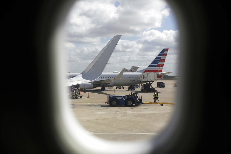 In this June 16, 2018, file photo, American Airlines aircrafts aircrafts are seen at O"Hare International Airport in Chicago. Newer seat-back entertainment systems on some airplanes operated by American Airlines and Singapore Airlines have cameras, and it's likely they are also on planes used by other carriers. American and Singapore both said Friday, Feb. 22, 2019, that they have never activated the cameras and have no plans to use them. (AP Photo/Kiichiro Sato, File)