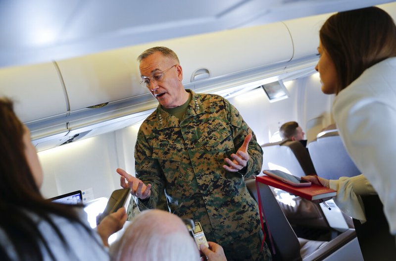Joint Chiefs Chairman Gen. Joseph Dunford gestures while speaking to reporters during a briefing on a military aircraft before arrival at El Paso International airport, Saturday, Feb. 23, 2019. Dunford is traveling with Acting Secretary of Defense Patrick Shanahan and they are planning to pay a visit to Texas-Mexico border. (AP Photo/Pablo Martinez Monsivais, Pool)