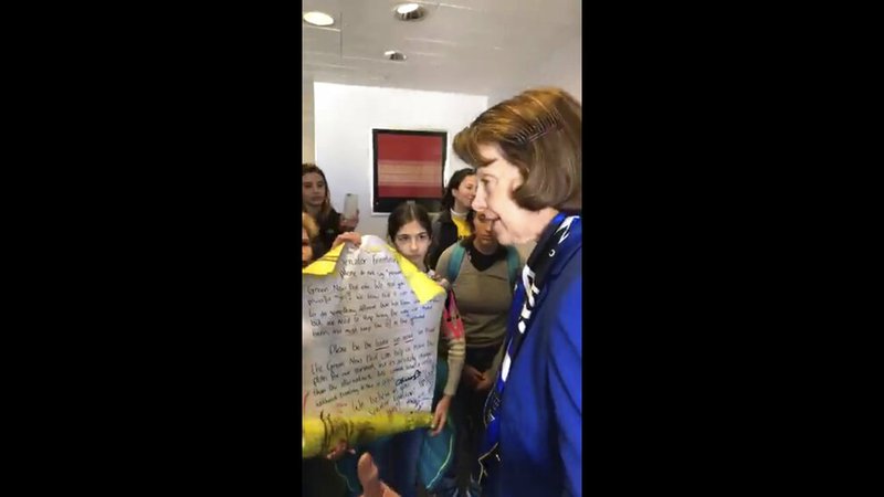 In this image from video provided by Morissa Zuckerman, U.S. Sen. Dianne Feinstein, D-Calif., speaks with a group of students who wanted to discuss the Green New Deal, an ambitious Democrat plan to shift the U.S. economy from fossil fuels and to renewable sources such as wind and solar power, at her office in San Francisco. The students are members of Sunrise Movement, an activist group that encourages children to combat climate change. (Morissa Zuckerman via AP)