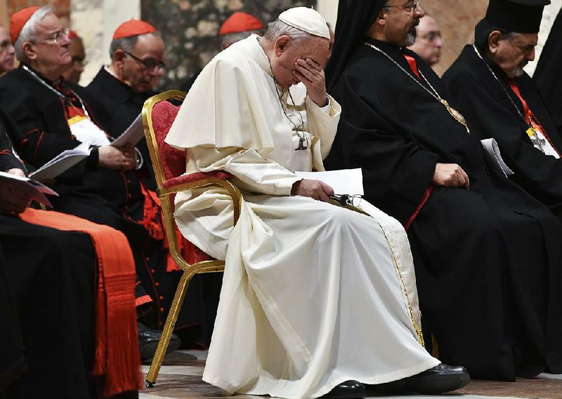 Pope Francis bows his head Saturday during a penitential liturgy at the Vatican, part of a gathering that included frank testimony about church leaders' silence on clergy sexual abuse.