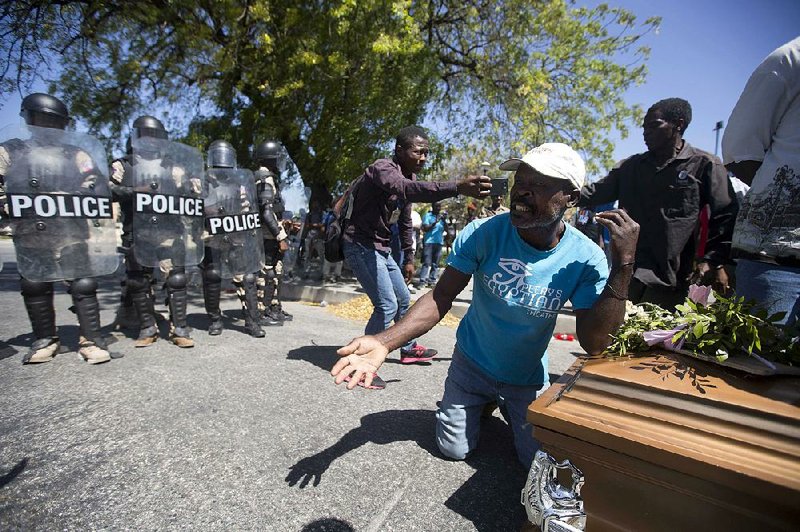 Demonstrators in Port-au-Prince, Haiti, arrive at the National Palace on Friday with a coffin containing the body of a protester who was killed last week. Citizens have been gathering to protest skyrocketing inflation and the government’s failure to prosecute embezzlement from a multibillion Venezuelan program that sent discounted oil to Haiti. 