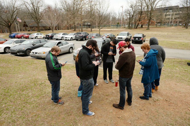NWA Democrat-Gazette/ANDY SHUPE A group of Pokemon Go players assembles Thursday while playing together at Veterans Memorial Park in Fayetteville. About $26 million for parks is included in Fayetteville's $226 million bond referendum set for April 9. Veterans Memorial Park would get about $1 million in improvements, along with new trails, lake decks and work on the ball fields.