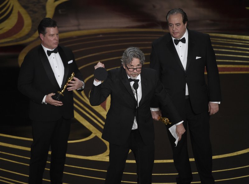 Brian Hayes Currie, from left, Peter Farrelly and Nick Vallelonga accept the award for best original screenplay for "Green Book" at the Oscars on Sunday, Feb. 24, 2019, at the Dolby Theatre in Los Angeles. (Photo by Chris Pizzello/Invision/AP)

