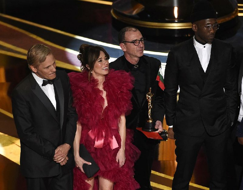 Green Book cast members (from left) Viggo Mortensen, Linda Cardellini, Dimiter Marinov and Mahershala Ali accept the best picture award during the Academy Awards presentations Sunday at the Dolby Theatre in Los Angeles. Ali also won the best supporting actor award.