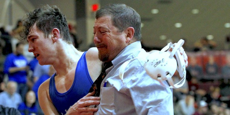 Arkansas Democrat-Gazette/Thomas Metthe FAMILY WINNER: Lakeside senior, left, Colton Burchard celebrates with his father, Rams' head wrestling coach H.E. Burchard, Saturday after his win against Searcy's Brad Brown in the Class 5A 152-pound state championship match at the Jack Stephens Center in Little Rock.