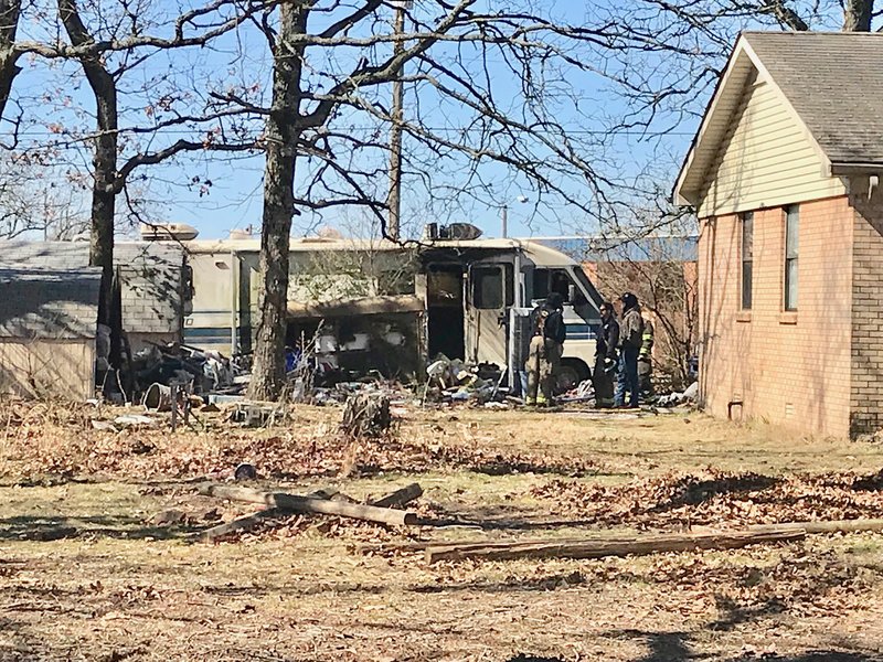 Westside Eagle Observer/JANELLE JESSEN Firefighters stand outside of a motorhome in Decatur which was destroyed by fire on Sunday morning (Feb. 24, 2019). A Decature man died in the fire.