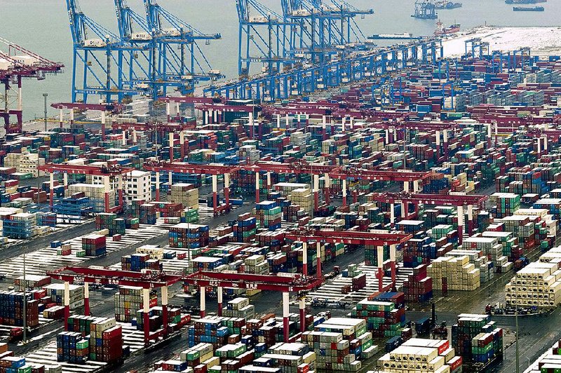 Containers are stored at a port earlier this month in Qingdao, China. U.S. President Donald Trump pushed back a deadline this Friday to escalate tariffs on Chinese imports, citing “substantial progress” in weekend talks between the two countries. 