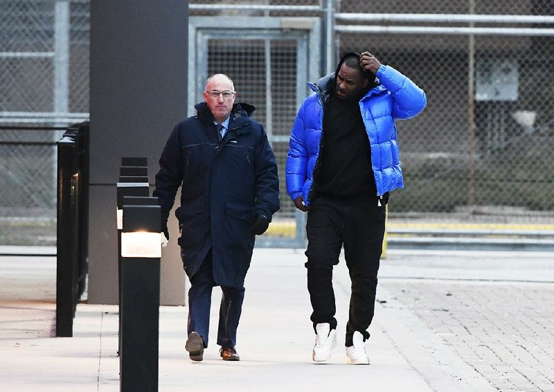 R. Kelly (right) leaves the Cook County jail with his defense attorney, Steve Greenberg, on Monday in Chicago.