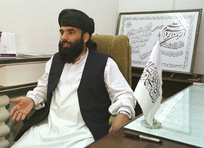 In this Nov. 14, 2001 file photo, Suhail Shaheen, then Deputy ambassador of the Islamic Republic of Afghanistan, gives an interview in Islamabad, Pakistan. Shaheen, a spokesman for the Taliban said that they are close to reaching an agreement on U.S. troop withdrawal from Afghanistan, expressing optimism amid a new round of talks with Washington's peace envoy in Qatar. He said the deal will also include guarantees that Afghanistan will not be used again as a staging arena for anti-American attacks. (AP Photo/Tariq Aziz)