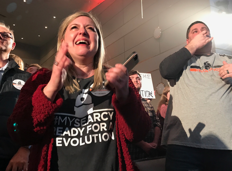 Shelley Faulkner celebrates alongside her husband, Mat Faulkner (right) after learning Searcy won $500,000 and will be featured in the reality show Small Business Revolution - Main Street. Mat Faulkner was the master of ceremonies at Tuesday's announcement at Harding University’s Benson Auditorium.