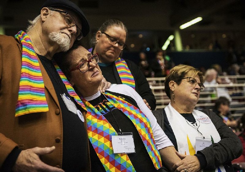 Delegates Ed Rowe (from left), Rebecca Wilson, Robin Hager and Jill Zundel react Tuesday at the United Methodist Church conference in St. Louis to the defeat of a proposal to let regional and local church groups decide whether to accept same-sex marriage and gay, bisexual and transgender clergy. A proposal by conservative members called the Traditional Plan was later approved. 