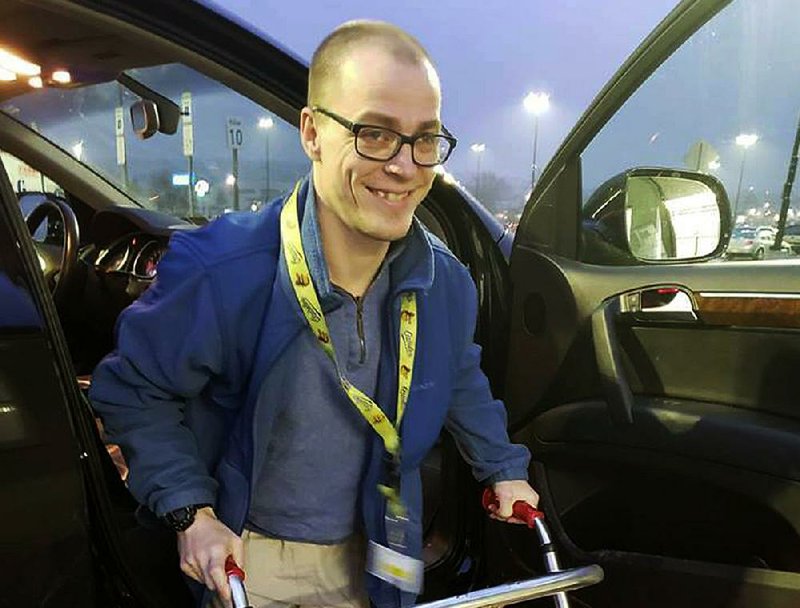 Adam Catlin gets ready to start his shift at a Walmart in Selinsgrove, Pa. Catlin, who has cerebral palsy, is afraid he’ll be out of work after store officials changed his job description to add tasks that he’s physically unable to do. 