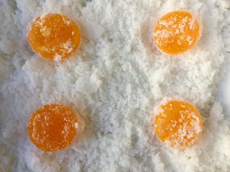 Egg yolks cure in a mixture of salt and sugar for several days before being dried in a low oven. 