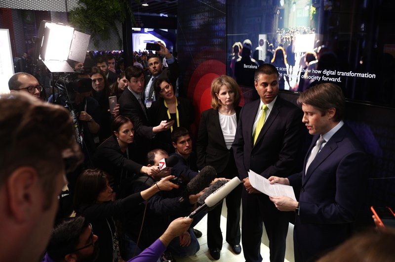U.S. Deputy Assistant secretary for Cyber and International Communications and Information Policy Robert Strayer, right, and Ajit Pai, Chairman of the Federal Communications Commission, centre, attend a press conference at the Mobile World Congress wireless show, in Barcelona, Spain, Tuesday, Feb. 26, 2019. The annual Mobile World Congress (MWC) runs from 25-28 February in Barcelona, where companies from all over the world gather to share new products. (AP Photo/Manu Fernandez)
