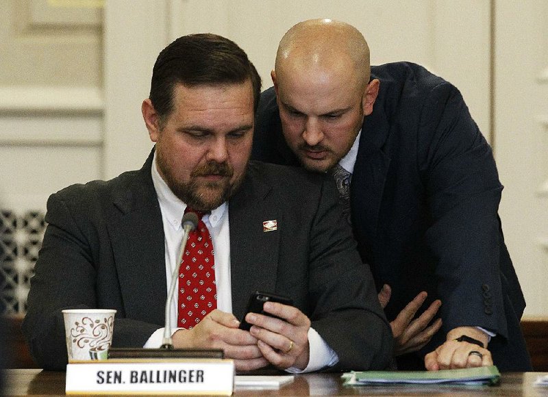 Sen. Bob Ballinger (left) and colleague Trent Garner confer Wednesday during  the Senate State Agencies and Governmental Affairs Committee meeting in which members discussed the proposals on the state’s initiative and referendum process and on term limits. 