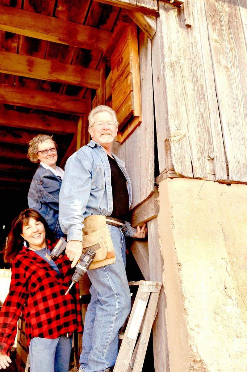 RACHEL DICKERSON/MCDONALD COUNTY PRESS Missouri Master Naturalist Joyce Haynes (left) joins Missouri Master Naturalists Joyce and Ron Johnson next to a bat house they installed in Haynes' barn.