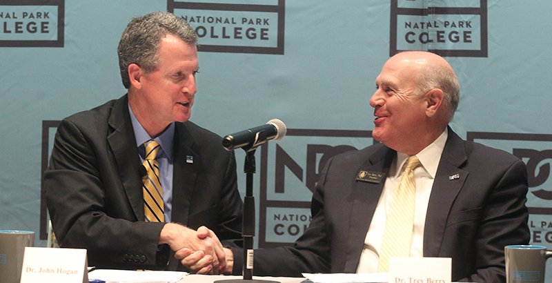 The Sentinel-Record/Richard Rasmussen SHAKE ON IT: National Park College President John Hogan, left, and Southern Arkansas University President Trey Berry shake hands after the NPC board of trustees approved a program to offer bachelor's degrees on campus on Wednesday.