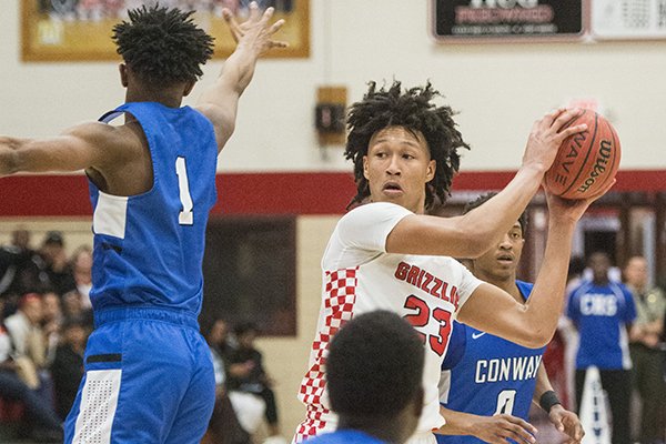 Jaylin Williams (23) of Fort Smith Northside looks to pass under pressure from Conway defenders Tuesday, Feb. 12, 2019, at Kaundart Fieldhouse in Fort Smith.
