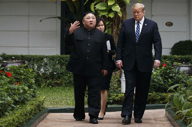 President Donald Trump and North Korean leader Kim Jong Un take a walk Thursday after one of their meetings in Hanoi, Vietnam. 