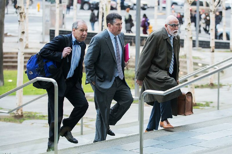 Attorneys for Huawei Technologies Co. arrive Thursday at federal court in Seattle, where they entered an innocent plea on behalf of the company. 