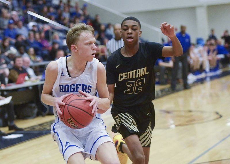 Rogers freshman guard Will Liddell (left) pulls up for a shot in front of Little Rock Central sophomore guard Corey Camper during the Mounties’ victory Thursday. Liddell scored 14 points as the Mounties won a state tournament game for the first time since 2011.