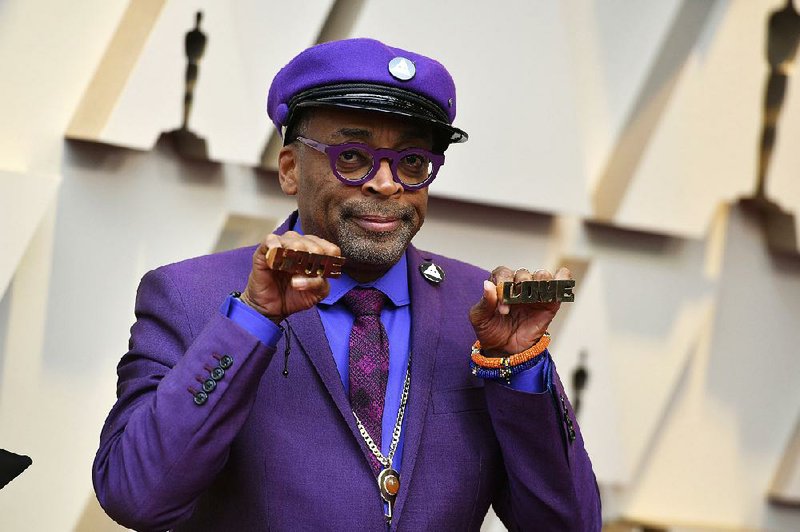 Spike Lee shows off the brass knuckles reading “hate” and “love” from his iconic film Do The Right Thing as he arrives at the Oscars last week. 